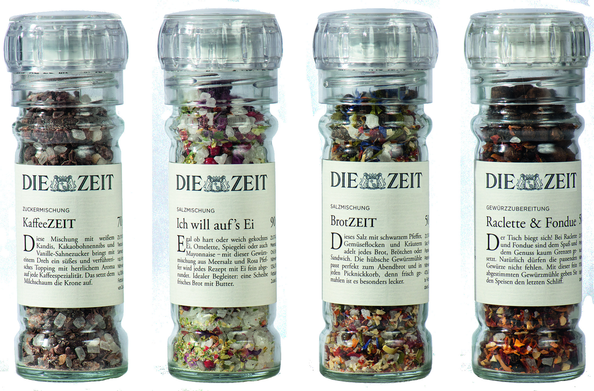 Bild zeigt ein 4er ZEIT Gewürzmühlen-Set mit verschiedenen Gewürzmischungen in transparenten Mühlen. Jede Mühle ist beschriftet und enthält bunte Gewürze.