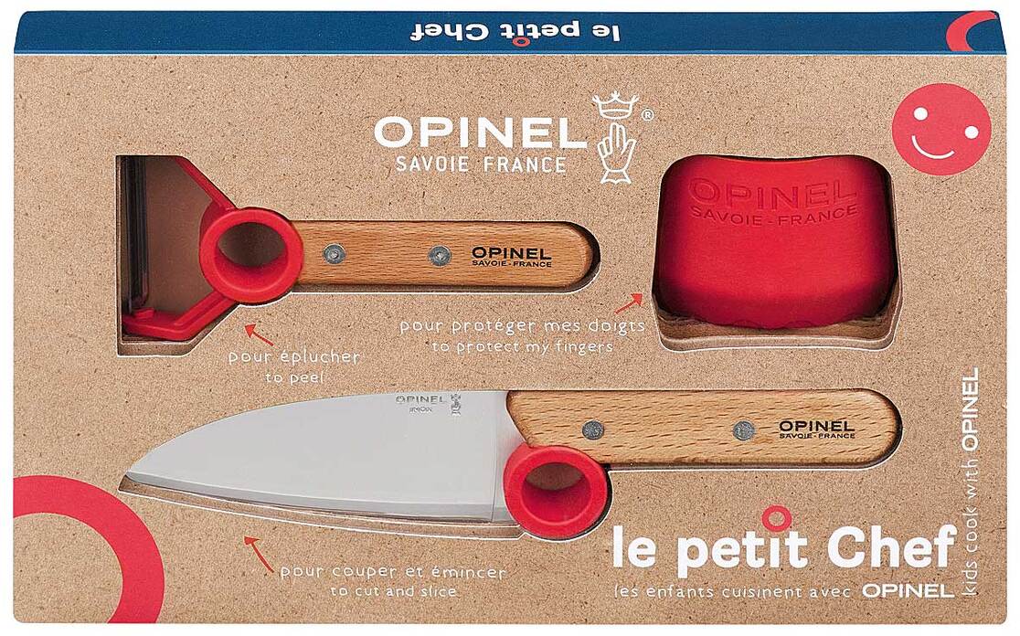 Ein Kinder Kochmesser-Set mit einem roten Schutzring und einem Messer mit Holzgriff. Verpackt in einer rechteckigen Box mit der Aufschrift 