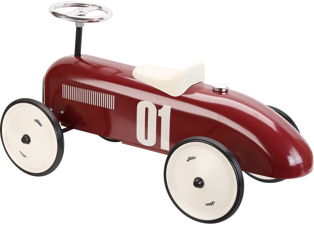 Rotes Vintage-Auto, das Spielzeugauto aus Metall im Retro-Stil, mit weißem Sitz und Lenkrad, sowie weißen Reifen und schwarzen Felgen