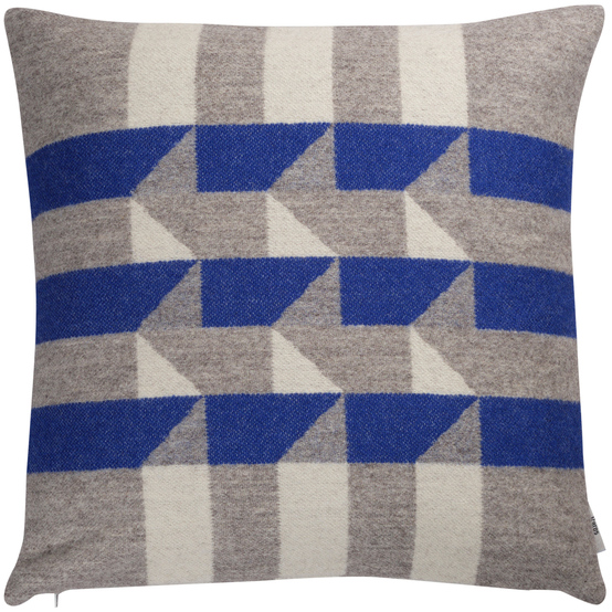 Ein quadratisches, geometrisch gemustertes Kissen mit blauen, grauen und weißen Streifen. Das Kissen trägt den Namen »KVAM«.